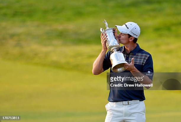 Justin Rose of England celebrates with the U.S. Open trophy after winning the 113th U.S. Open at Merion Golf Club on June 16, 2013 in Ardmore,...