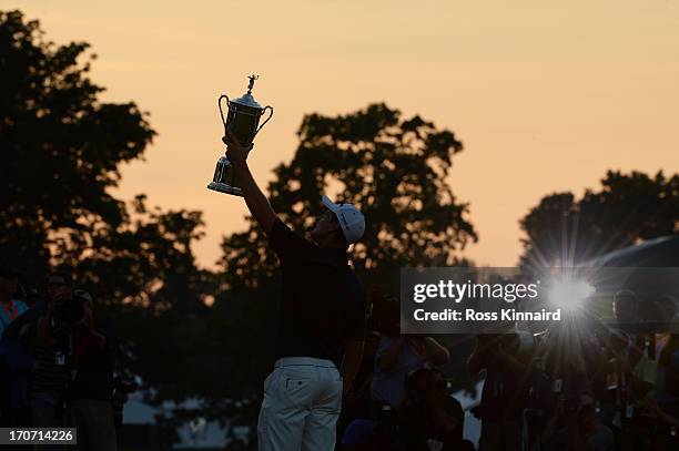 Justin Rose of England celebrates with the U.S. Open trophy after winning the 113th U.S. Open at Merion Golf Club on June 16, 2013 in Ardmore,...