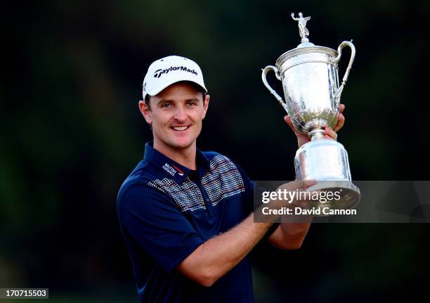 Justin Rose of England celebrates with the U.S. Open trophy after winning the 113th U.S. Open at Merion Golf Club on June 16, 2013 in Ardmore,...