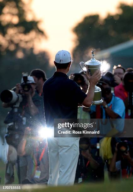 The media photographs Justin Rose of England as he celebrates with the U.S. Open trophy after winning the 113th U.S. Open at Merion Golf Club on June...