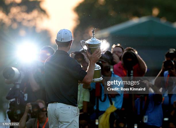 The media photographs Justin Rose of England as he celebrates with the U.S. Open trophy after winning the 113th U.S. Open at Merion Golf Club on June...