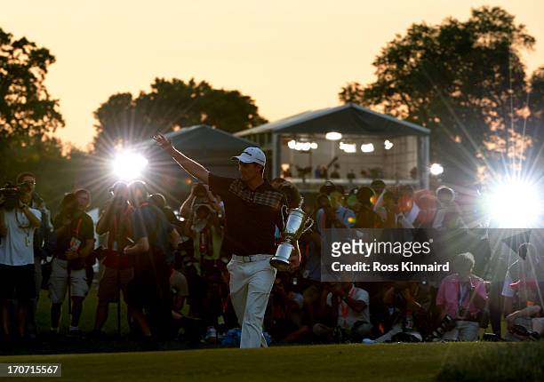 The media photographs Justin Rose of England as he celebrates with the U.S. Open trophy after winning the 113th U.S. Open at Merion Golf Club on June...