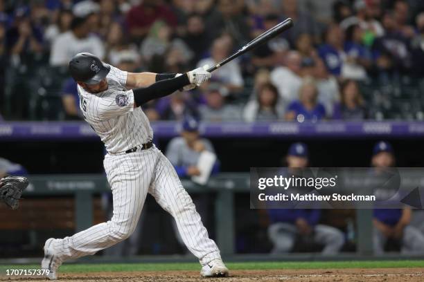 Austin Wynns of the Colorado Rockies hits an RBI single against the Los Angeles Dodgers in the seventh inning at Coors Field on September 28, 2023 in...