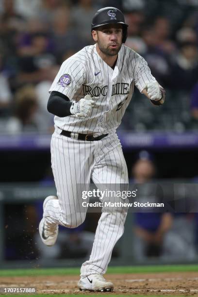 Austin Wynns of the Colorado Rockies celebrates after hitting an RBI single against the Los Angeles Dodgers in the seventh inning at Coors Field on...