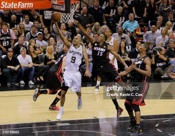 Tony Parker of the San Antonio Spurs goes up for a shot in front of Mario Chalmers of the Miami Heat in the second half during Game Five of the 2013...