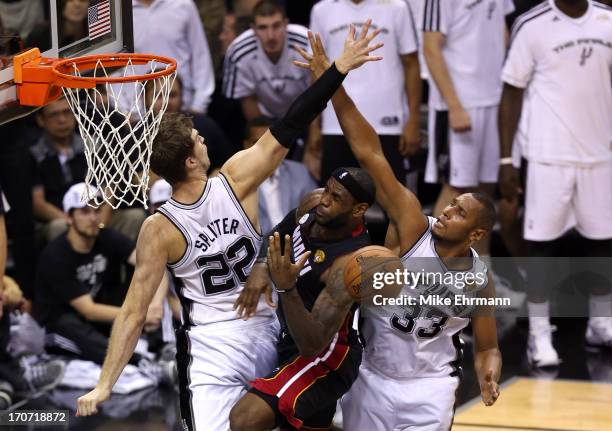 LeBron James of the Miami Heat goes up for a shot against Tiago Splitter and Boris Diaw of the San Antonio Spurs in the second half during Game Five...