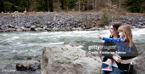mother and daughter looking at river - chilliwack stock pictures, royalty-free photos & images