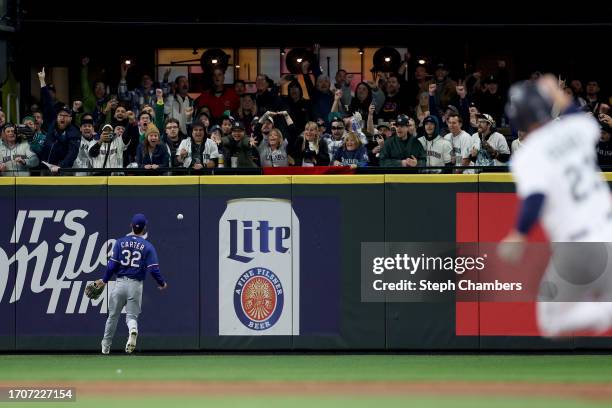 Evan Carter of the Texas Rangers watches a walk-off double from J.P. Crawford of the Seattle Mariners during the ninth inning at T-Mobile Park on...