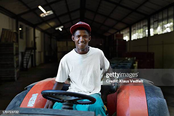 portrait of male wineworker sitting on tractor - stellenbosch ストックフォトと画像