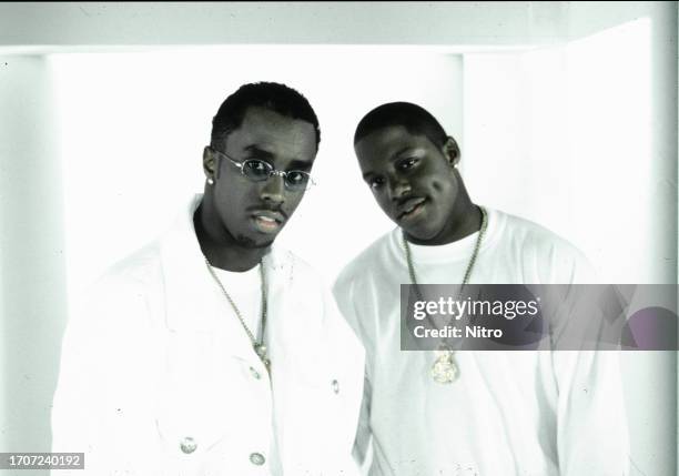 View of American rappers Sean Combs , performing as Puff Daddy, and Mase on the set of the 'Can't Nobody Hold Me Down' music video, Apple Valley...