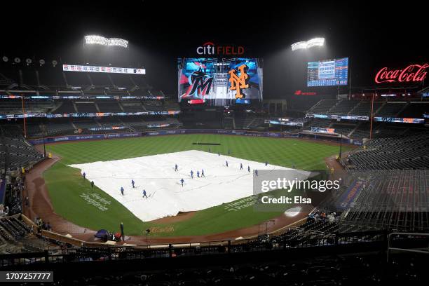 The Grounds crew pull the tarp back on the field at Citi Field on September 28, 2023 in the Flushing neighborhood of the Queens borough of New York...
