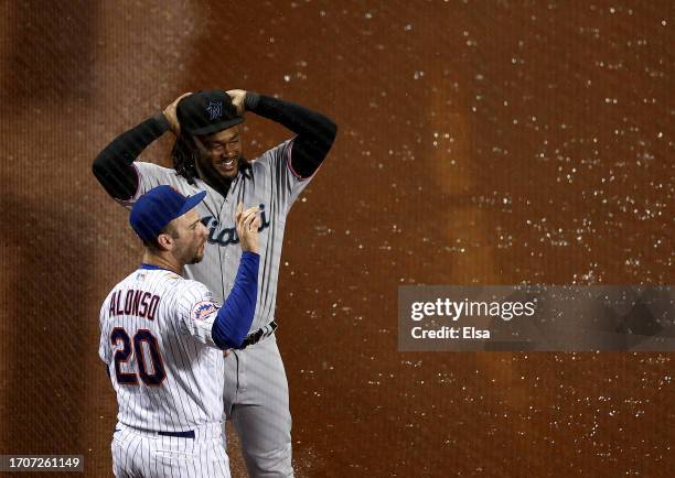 Josh Bell of the Miami Marlins and Pete Alonso of the New York Mets talk during a rain delay at Citi Field on September 28, 2023 in the Flushing...