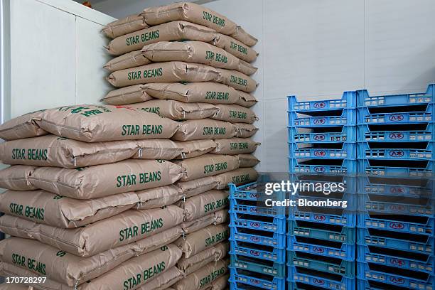 Bags of soybeans are stacked next to crates at the Matsushita Shoten Y.K. Production facility in Kawasaki, Kanagawa Prefecture, Japan, on Friday,...