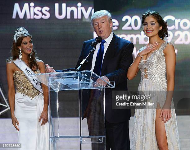 Donald Trump speaks onstage as Miss Connecticut USA Erin Brady and Miss Universe 2012 Olivia Culpo look on during a news conference after Brady won...