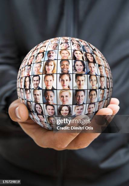 hand holding sphere with grid of many faces - multiple devices stock-fotos und bilder