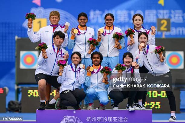 Silver medallists Taiwan's Chen Yi-hsuan, Wang Lu-yun and Huang I-jou, gold medallists India's Parneet Kaur, Aditi Swami and Jyothi Vennam, and...