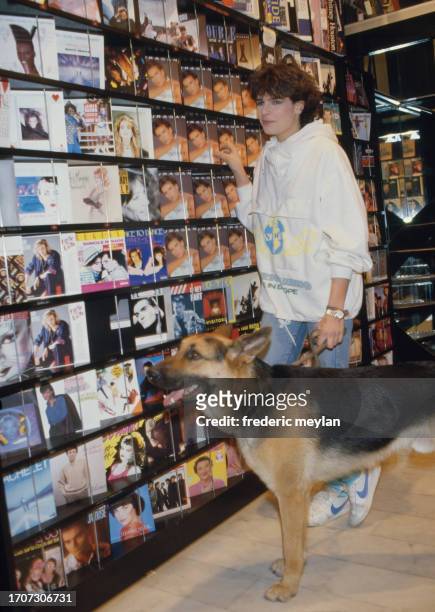 Princess Stephanie of Monaco with her dog in a record store. Paris, 8 March 1986.