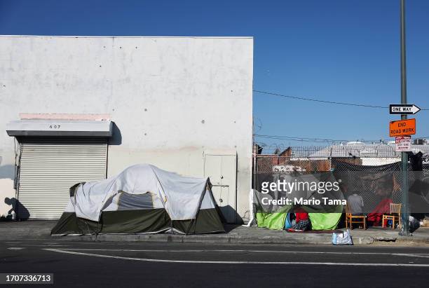 People are gathered at a homeless encampment in the Skid Row community on September 28, 2023 in Los Angeles, California. State and local lawmakers,...