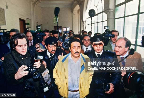 Picture dated 18 February 1992 of Libyan Khalifa Fhimah escorted by security officers and journalists before appearing at the Supreme court for a...