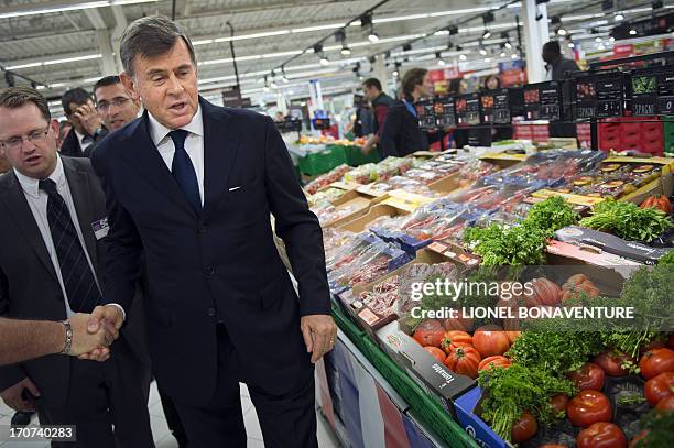 Carrefour retailing group chief operating officer Georges Plassat visits a Carrefour supermarket on June 17, 2013 in Sainte-Genevieve-des-Bois,...