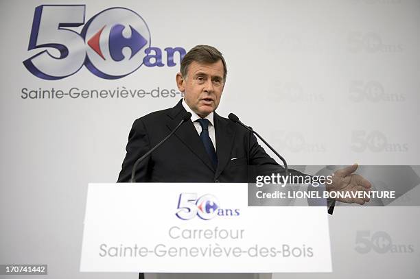 Carrefour retailing group chief operating officer Georges Plassat speaks during a visit at a Carrefour supermarket on June 17, 2013 in...