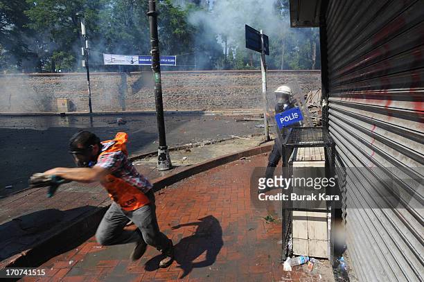 An anti-government protester is challenged by a police officer in the Kurtulus district on June 16, 2013 in Istanbul, Turkey. Protests which started...