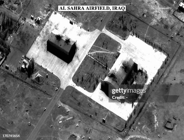 This photo released 18 December by the US Department of Defense and used in a Pentagon briefing shows bomb damage to two hangars at the Al Sahra...