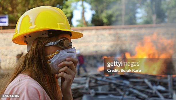 An anti-government protester stands in front of burning barricades in Kurtulus district on June 16, 2013 in Istanbul, Turkey . Protests which started...