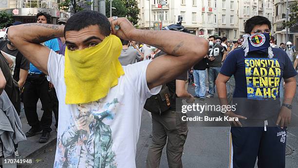 Anti-government protestors cover their faces during clashes with police in the Tesvikiye district on June 16, 2013 in in Istanbul, Turkey. Protesters...
