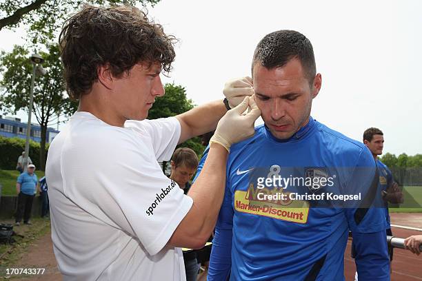 Christian Tiffert of VfL Bochum gives blood during a fitness test at the club's training ground on June 17, 2013 in Bochum, Germany.