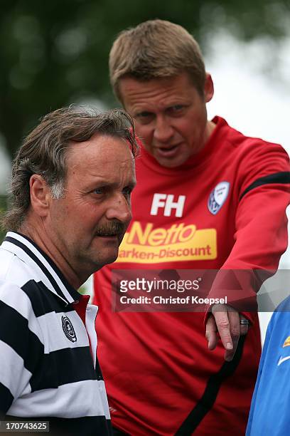 Assistant coach Frank Heinemann and head coach Peter Neururer of Bochum watch a fitness test at the club's training ground on June 17, 2013 in...