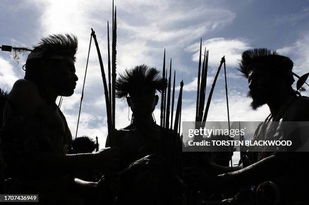 Hila Lekena warriors from Lufa gather on the outskirts of town before marching to the 50th Goroka singsing in what is believed to be the largest...