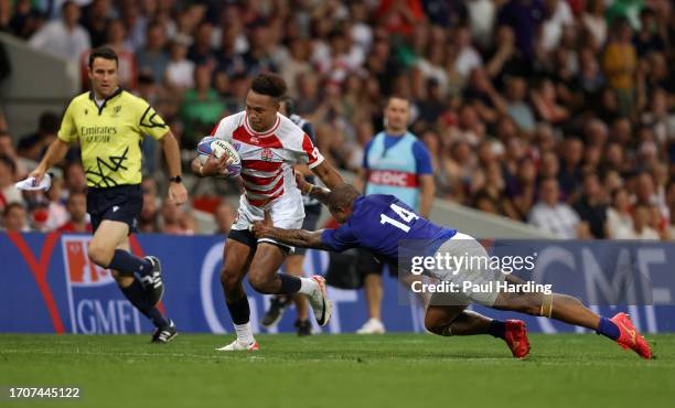 Kotaro Matsushima of Japan is tackled by Ed Fidow of Samoa during the Rugby World Cup France 2023 match between Japan and Samoa at Stadium de...