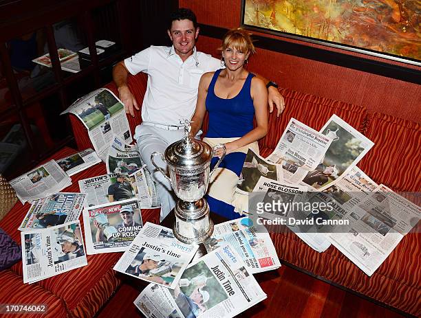 Justin Rose of England and his wife Kate Rose and the morning papers as they looked at the photographs and stories of his 2013 US Open win at Merion...