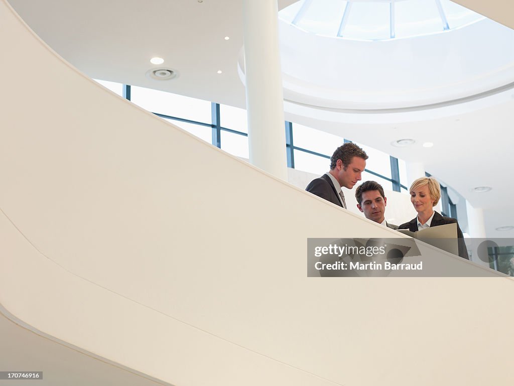 Business people standing on staircase