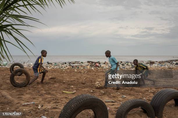 Guinean youth play soccer amidst garbage as pollution at the beaches, due to poor infrastructure and lack of founding, threatens lives in Conakry,...