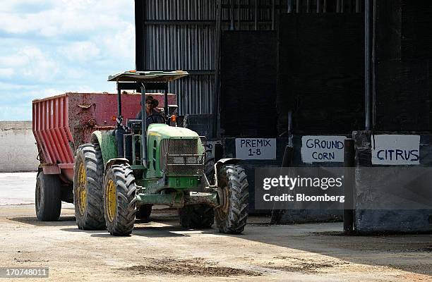 Worker drives a feed-spreader to pick up a load of scientifically-blended cattle feed at J.M. Larson Dairy 3 in Okeechobee, Florida, U.S., on Friday,...