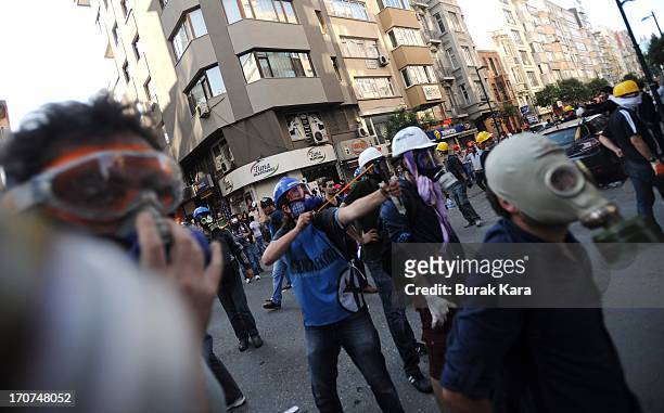 An anti-government protester uses a catapult during clashes with police in the Kurtulus district on June 16, 2013 in Istanbul, Turkey. Protests which...