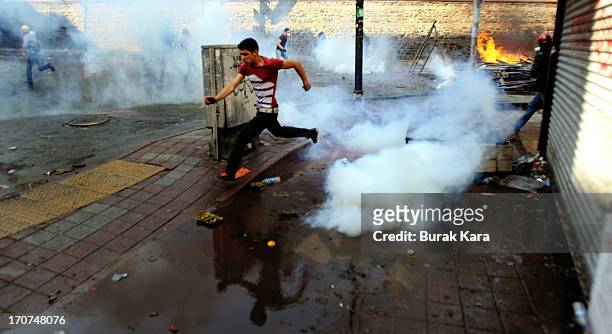 An anti-government protester runs as police fire tear gas at demostrators in Kurtulus district on June 16, 2013 in Istanbul, Turkey. Protests which...