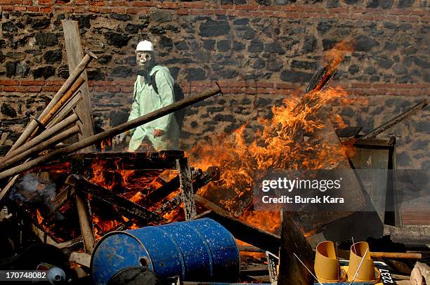 An anti-government protester stands in front of burning barricades in Kurtulus district on June 16, 2013 in Istanbul, Turkey . Protests which started...