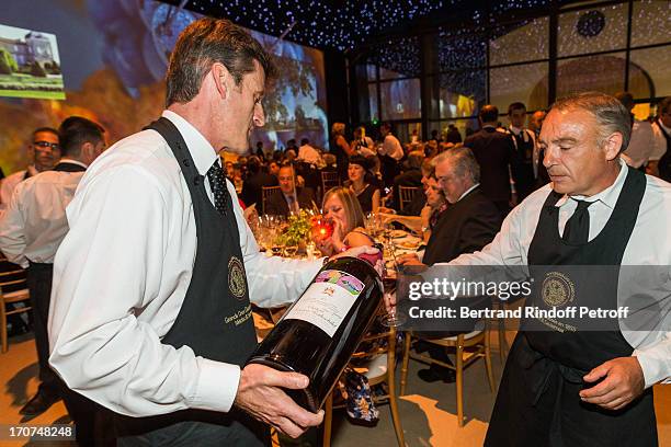 Sommeliers bring the wine for the guests during the dinner of Conseil des Grand Crus Classes of 1855 hosted by Chateau Mouton Rothschild on June 16,...