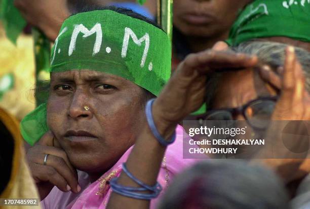 Santhal tribal supporters of Jharkhan Mukti Morcha listen to a speach during a rally in Calcutta 19 March 2001. The JMM supporters demanded that...