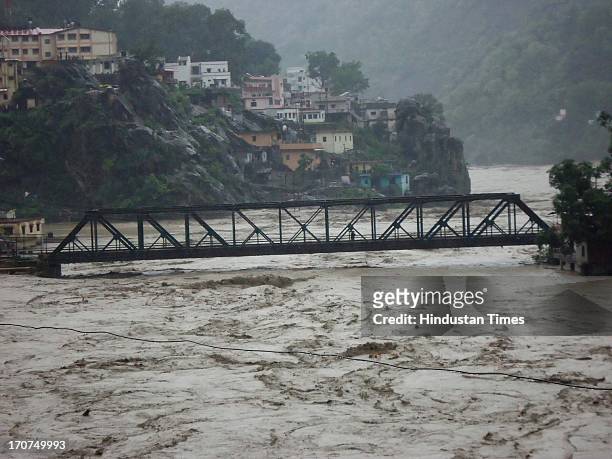 Several houses on the banks of Alaknanda River have fallen prey to the rise in water level post heavy rainfall on June 17, 2013 in Rudraprayag,...