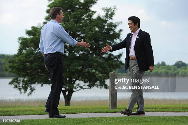 Britain's Prime Minister David Cameron welcomes Japan's Prime Minister Shinzo Abe during the official welcome for the start of the G8 Summit in at...