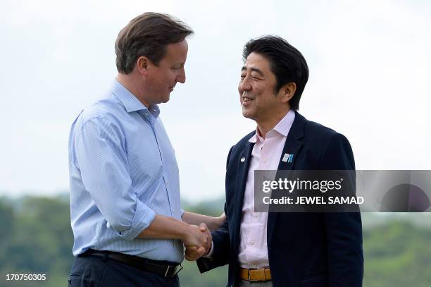 Britain's Prime Minister David Cameron welcomes Japan's Prime Minister Shinzo Abe during the official welcome for the start of the G8 Summit in at...