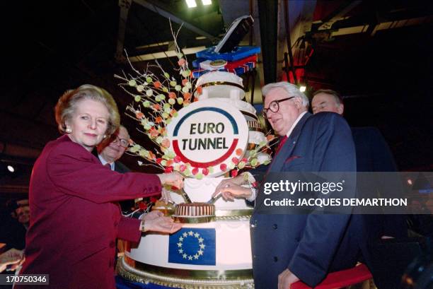 Picture taken on February 26, 1994 shows former British and French Prime Ministers Margaret Thatcher and Pierre Mauroy cutting a cake during the...