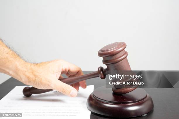 a judge passes sentence. a document is on the table. - verurteilung stock-fotos und bilder