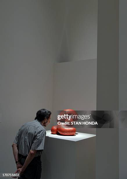 Man views "Little D, 2011" by artist Ken Price during a preview of "Ken Price Sculpture: A Retrospective" June 17, 2003 at the Metropolitan Museum of...