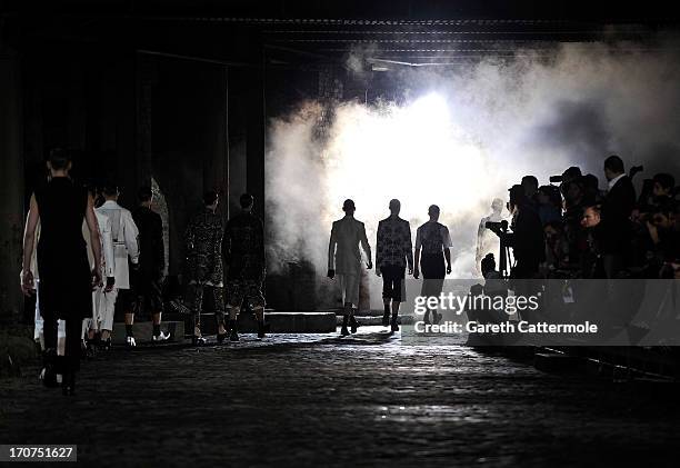 Models walk the runway during the Alexander McQueen show during the London Collections: MEN SS14 at The Coal Drops on June 17, 2013 in London,...