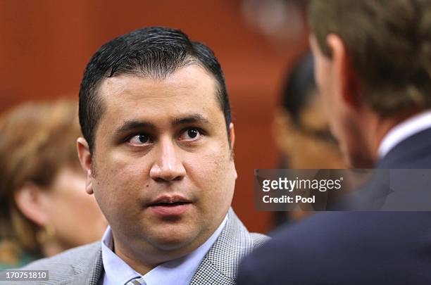 George Zimmerman talks to his attorney, Mark O'Mara, during a recess in Seminole circuit court on the sixth day of his murder trial June 17, 2013 in...